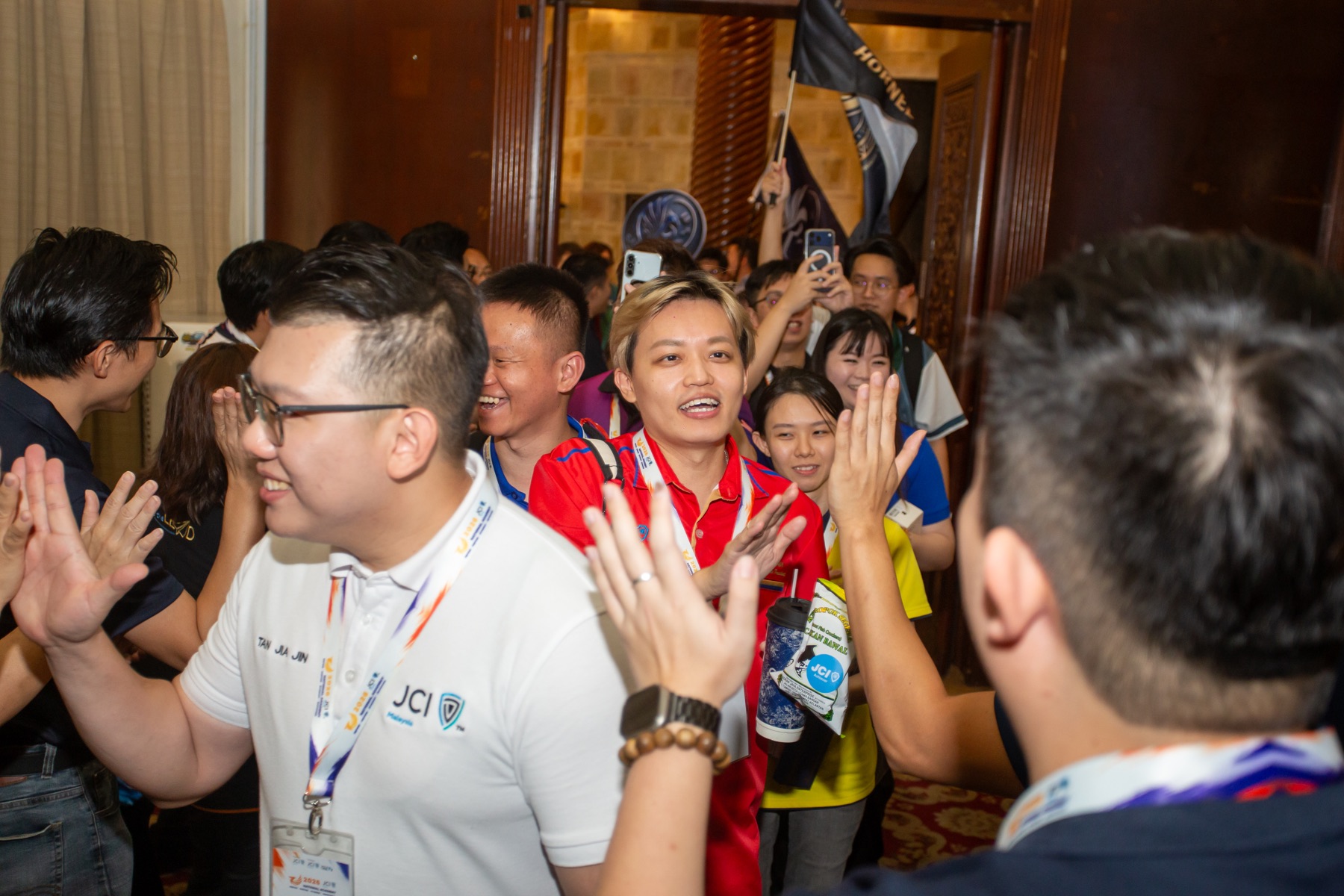 Academians entering the hall through a lively welcome line