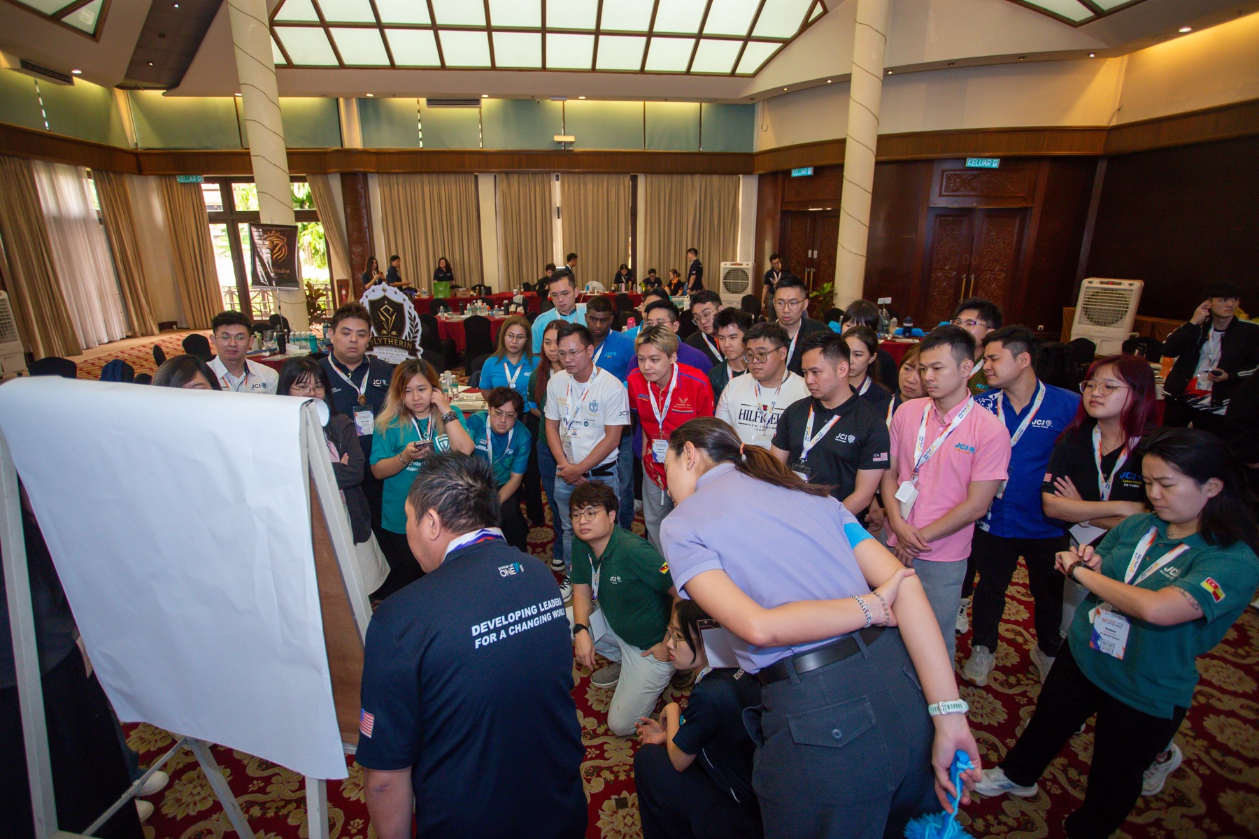 Academians gathering around a flip chart during group work