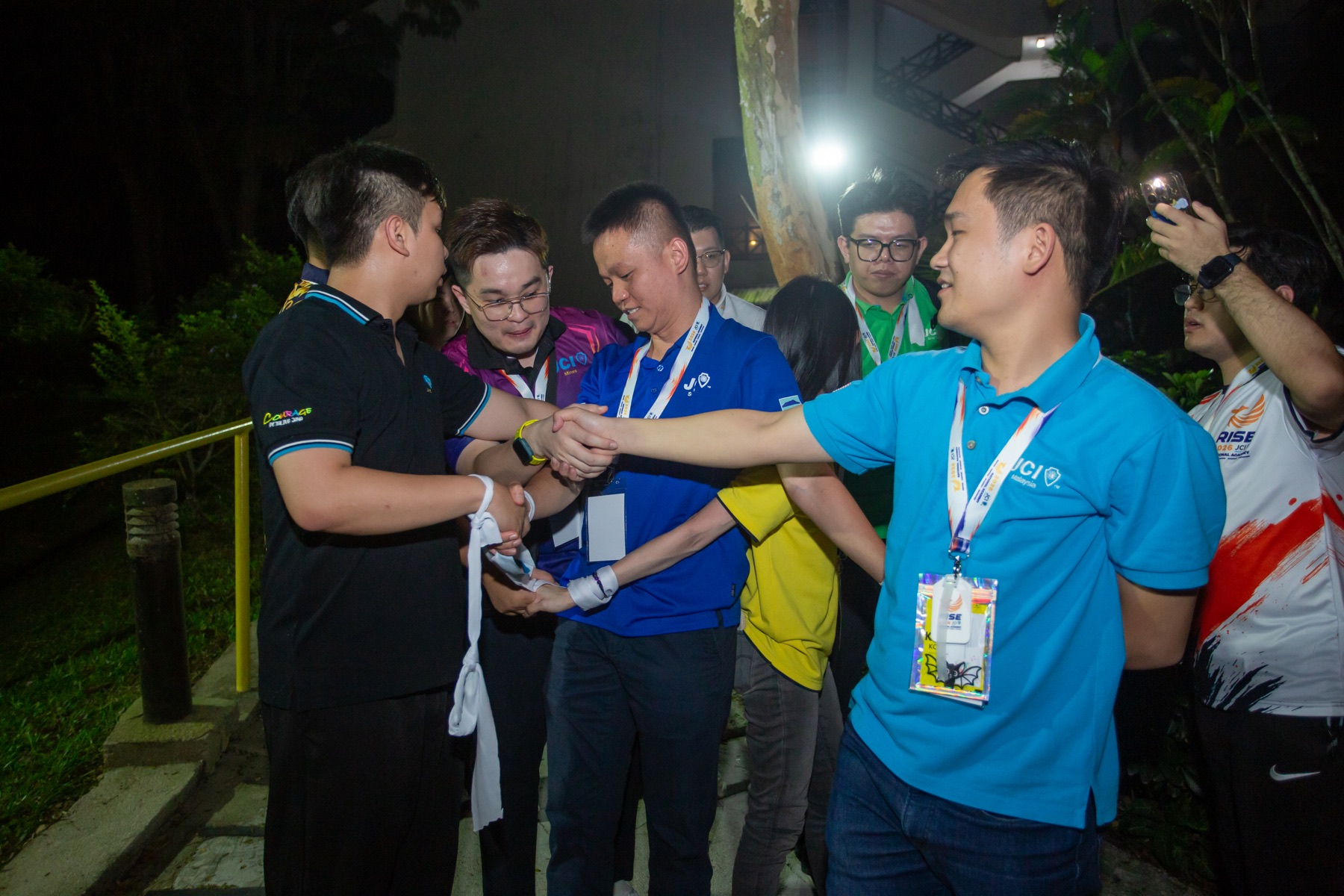 Academians linking hands during the RISE Challenge