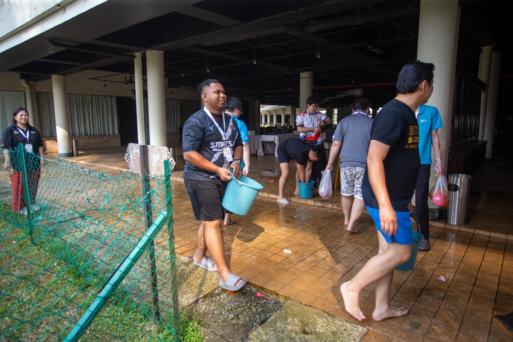 Academians carrying buckets during a team activity